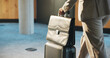© Flash25/peopleimages.com - Hand, business man and luggage for work travel, corporate conference or walking in lobby for industry symposium. Bag, suitcase and person in hotel foyer on professional trip for convention or seminar