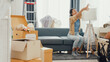© tirachard - Young happy Asian couple help each other moving box full of stuff unpacking furniture on sofa couch in living room at new house. Husband and wife move new house, Apartment Rent And Ownership Concept.