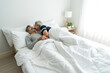© Kawee - Asian senior elderly couple lying down on bed, morning kiss each other.