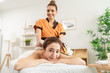 © Kawee - Portrait of Asian young masseuse woman and client looking at camera.