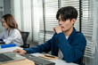 © Kawee - Asian attractive businessman employee working in the office workplace.
