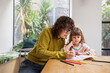 © ReeldealHD images - Mom teaching daughter how to write at home