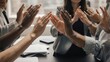 © Pugalas - Diverse group applauding in a business meeting, celebrating success.
