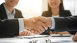 © Aansa Imran - Professional business handshake sealing agreement in modern office