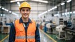© Vasiliy - Portrait of a smiling male factory worker wearing a yellow hard hat and orange safety vest. Professional engineer in a modern industrial manufacturing plant. Workplace safety concept