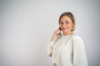 © Nenad - Businesswoman talking on phone looking at camera, isolated