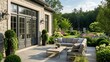 © Jawad - Elegant home exterior featuring a spacious patio with grey flagstones, large french doors, and a view of a lush garden.