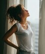 © ai_katrin - woman standing near open window or balcony taking deep breath of fresh air