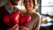 © Laura - Couple celebrating with heart balloons indoors, faceless anniversary or love concept, warm tones, with copy space