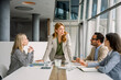 © Westend61 - Business team working and discussing in modern office meeting