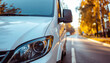 © MP-AI - White van autumn road eco friendly delivery transport street vehicle urban travel logistics foliage tree season yellow leaf sunset light reflection headlight windshield mirror side view road trip