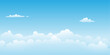© Christos Georghiou - A clear blue cloudy sky cartoon background with soft white clouds.