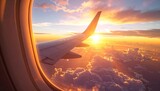 Aerial view of a plane wing flying above blue clouds and the horizon under a sunset sky from the airplane window