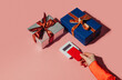© VISTA by Westend61 - Contactless payment with credit card and gift boxes on pink background