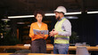 © RZ Images - Male project manager discussing building plan with female engineer in hard hat and safety vest
