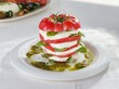 © Damian - Fresh slices of Mozarella and red tomatoes are beautifully arranged with basil leaves, drizzled with olive oil. This dish showcases the flavors of summer in a picturesque setting