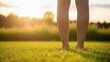© Bashar - Bare legs standing on vibrant green grass during golden hour sunset