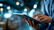 © Denis Yevtekhov - Faceless smart warehouse management system, worker hands holding tablet on blurred warehouse as background, digital inventory control, logistics technology, defocused hands, with copy space