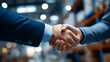 © Denis Yevtekhov - Faceless two men shake hands in warehouse, business agreement in storage facility, professional deal in distribution center, logistics partnership handshake, defocused people greeting, with copy