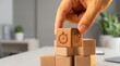 © Fernando - Hand stacking wooden blocks with stopwatch and brain icons, symbolizing time management and intelligence in business or productivity