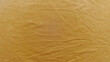 © Arthur - golden yellow wrinkled fabric texture closeup capturing soft folds and warm glow for wallpaper or banner background