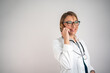 © Nenad - Female doctor talking on the phone with patients, isolated, copy space