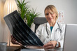 © Nenad - Female doctor looking at x-ray or MRI concept healthcare