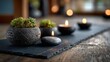 © MKS - The image shows a yoga mat, candles, stones, and plants arranged to create a calm scene, while the glow from the lit candles adds to the tranquil, Zen‑like atmosphere