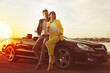 © New Africa - Stylish couple near luxury convertible car on sunny day