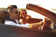 © New Africa - Stylish couple in luxury convertible car on sunny day