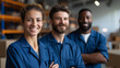 © Kateryna - Smiling diverse warehouse retail workers in blue uniforms standing together inventory management team stock control employees commercial distribution facility professional