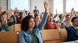 © Saqib GFX - Diverse students raising hands in university lecture hall classroom. Engagement participation learning education. Multiethnic group excited answering questions