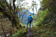 © Soloviova Liudmyla - Young female with backpack and poles trekking walking Mera Peak climbing route through jungle rain forest in Makalu Barun National Park, Nepal. Active people and Himalayas tourism concept image.