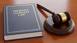 © Peahen - Product Liability Law book with wooden gavel on desk for legal consumer protection defective merchandise litigation and manufacturer responsibility accountability regulation