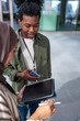 © Jovo Jovanovic/Stocksy - Two young people looking at digital tablet outdoors