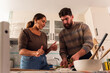 © Milles Team/Stocksy - Couple talking while cooking