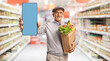 © Ljupco Smokovski - Senior man in supermarket holding phone
