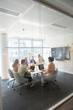 © Santi Nuñez/Stocksy - Business team collaborating on project in modern office meeting room