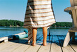 © Cara Dolan/Stocksy - Child's feet on the dock by the lake with towel