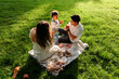 © Dani Nahuel/Stocksy - Little girl playing with parents during picnic