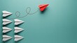 © Creative Stock - Red paper plane breaking away from a group of white paper planes on a teal background.