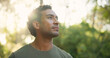 © BuyOutFelix06/peopleimages.com - Thinking, explore or man in forest with hiking, fresh air or contemplation on trekking journey. Reflection, bokeh or person in nature with thoughts, mindfulness or daydreaming in outdoor adventure.