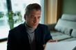 © Artcore Studio/Stocksy - Mature businessman reading focusing analyzing business document