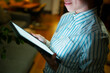 © Artcore Studio/Stocksy - Woman reading digital book on tablet at night