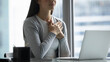 © fizkes - Inner relief and gratitude. Close up cropped shot young female office employee sitting at desk by laptop screen hold palms near heart feel thankful express sincere appreciation sympathy by videocall