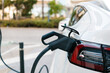 © Ezequiel Giménez/Stocksy - Electric car charging at station for sustainable future