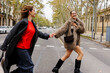 © BONNINSTUDIO/Stocksy - Happy female friends holding hands crossing street