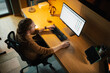 © Artcore Studio/Stocksy - Working late at night in a modern home office setup