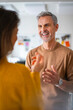 © Westend61 - Happy man with colleague discussing at office