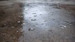 © Thares2020 - Detailed ro view of a wet concrete surface with water puddles droplets and reflections on a grey background